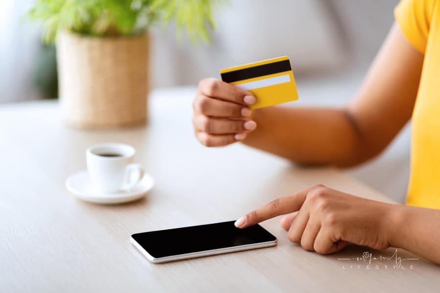 woman using smartphone and credit card