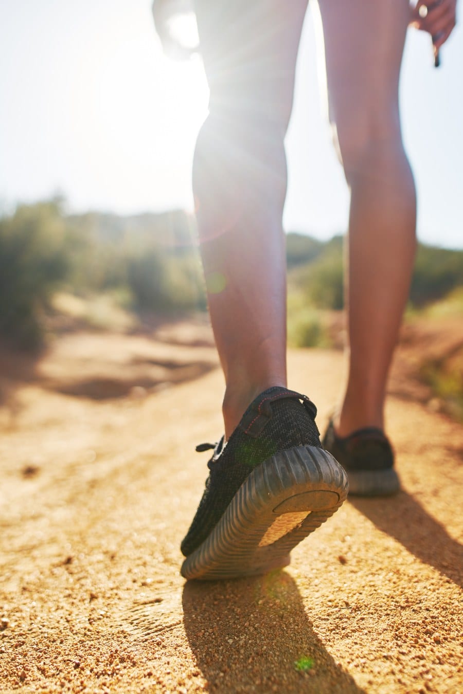 hiker walking on dirt path close up on shoes while walking
