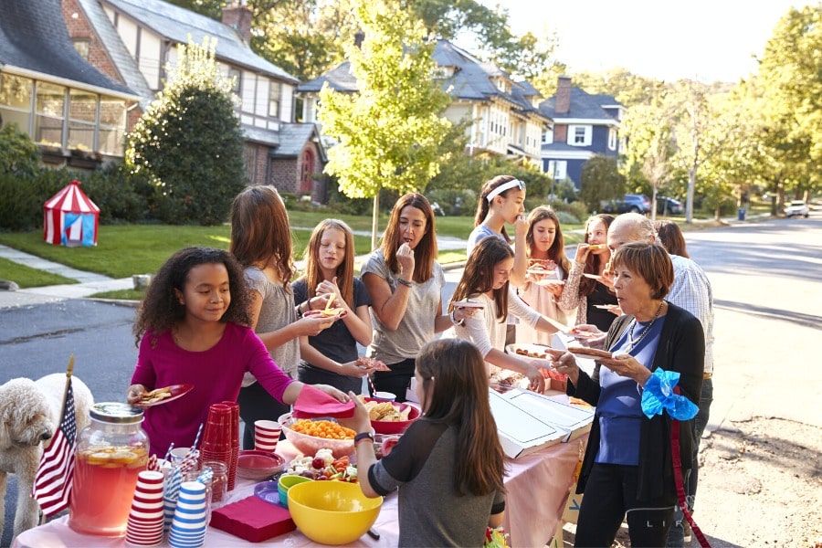 neighbors enjoying food at neighborhood block party