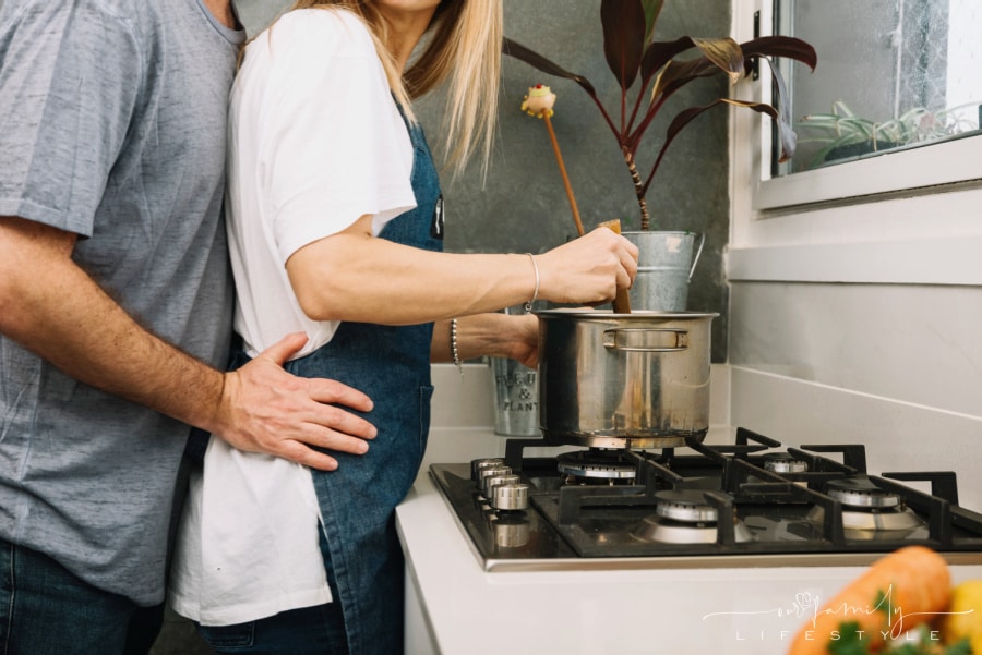 married couple cooking at stove together