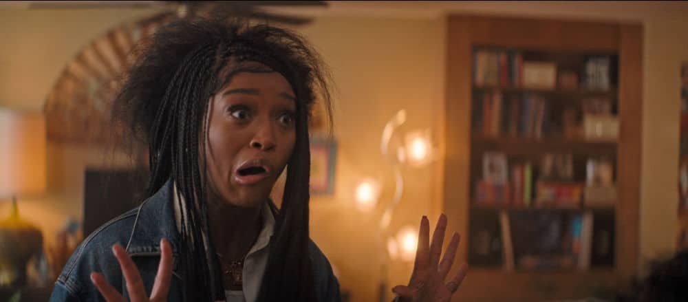 Keke Palmer with wide eyes and raised hands, looking hilariously shocked.