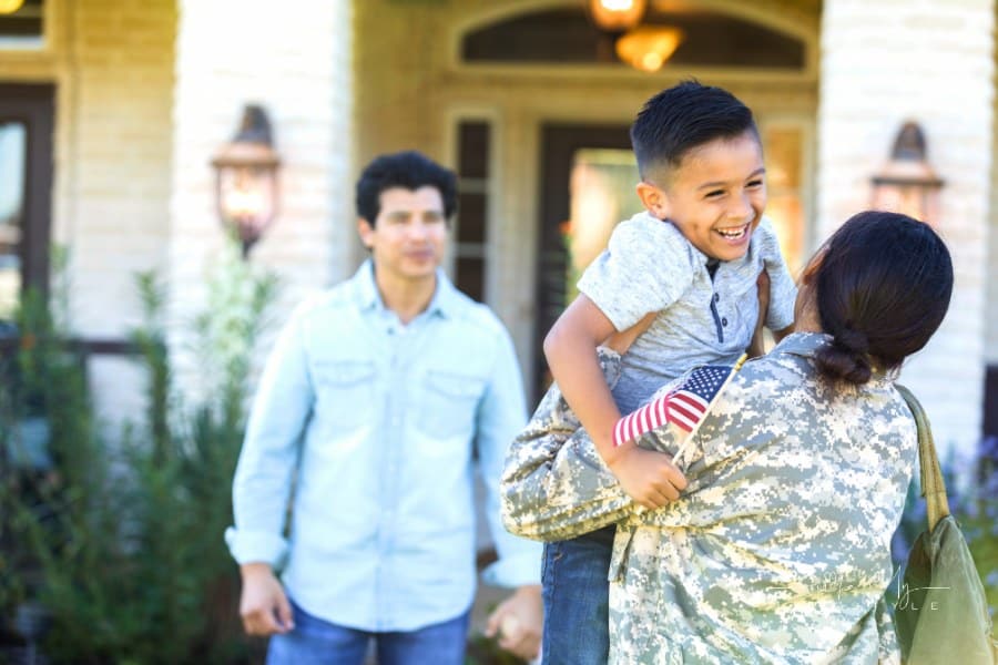 Excited boy greets millitary mom coming home from deployment
