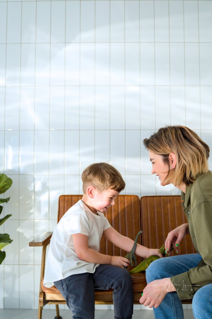 A Woman Playing with her Son on a Bench