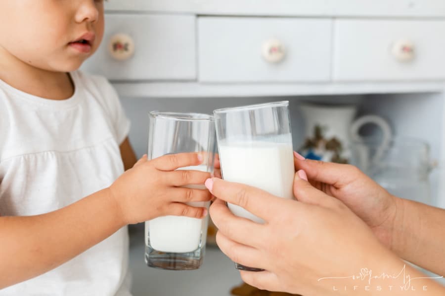 mother-daughter-hands-holding-milk-glasses