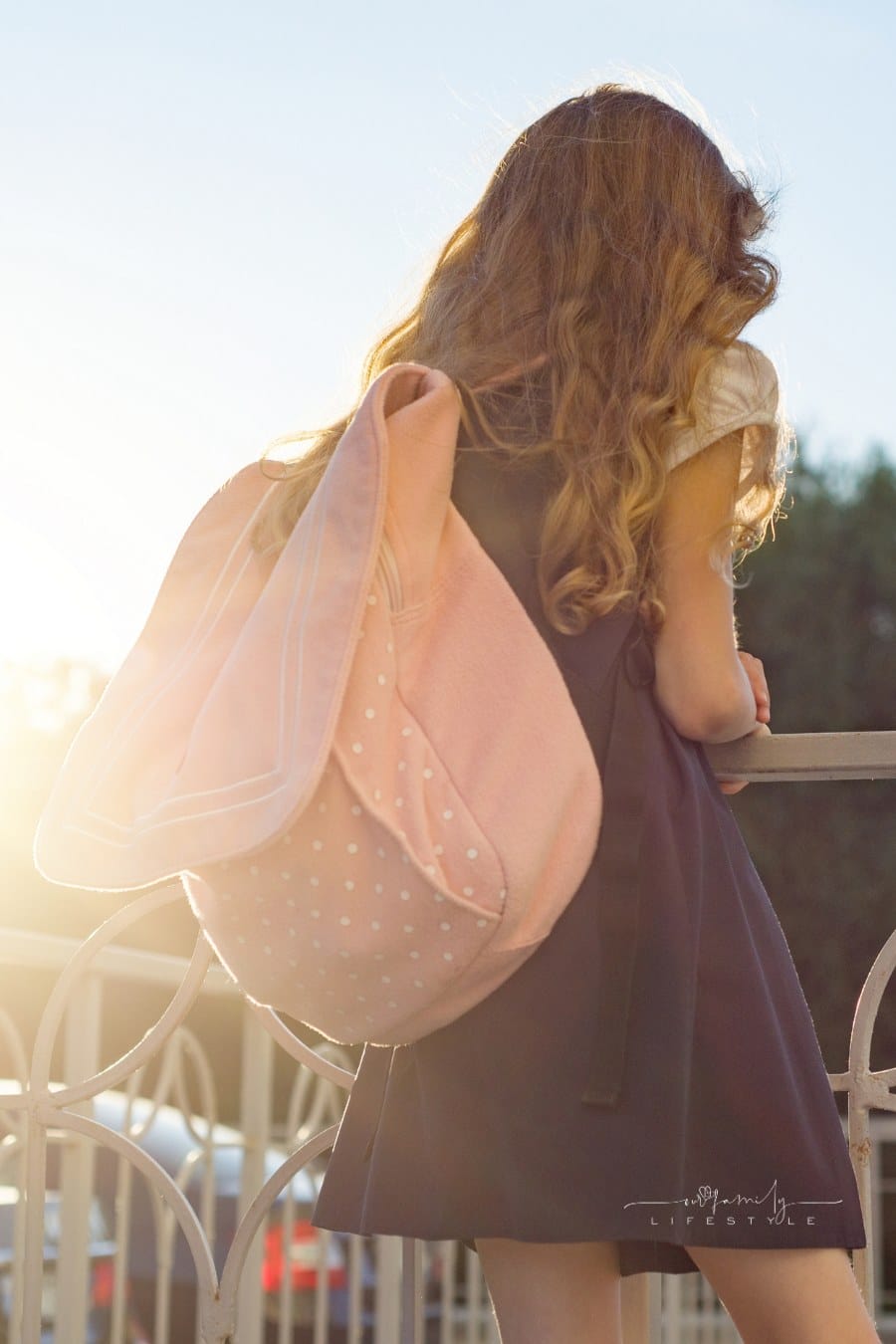 Girl with School Backpack in Uniform Standing with Her Back. Back to School, Child Looks Forward