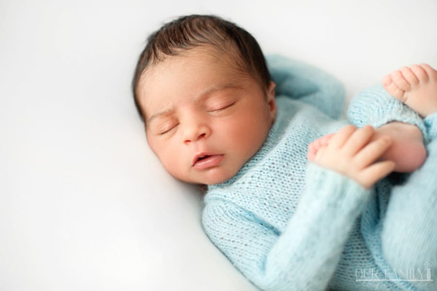 newborn-sleeping-baby-boy-white-chair-cute-blue-crocheted