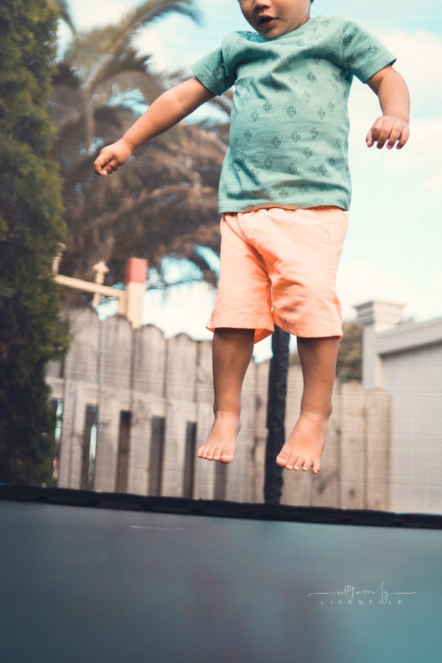 young child jumping on trampoline