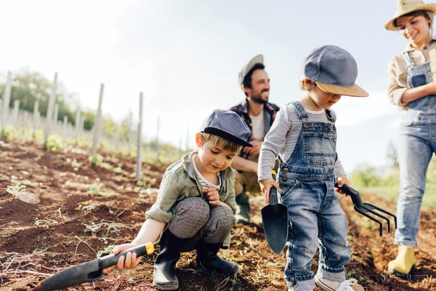 Photo of a happy family working together on their organic farm