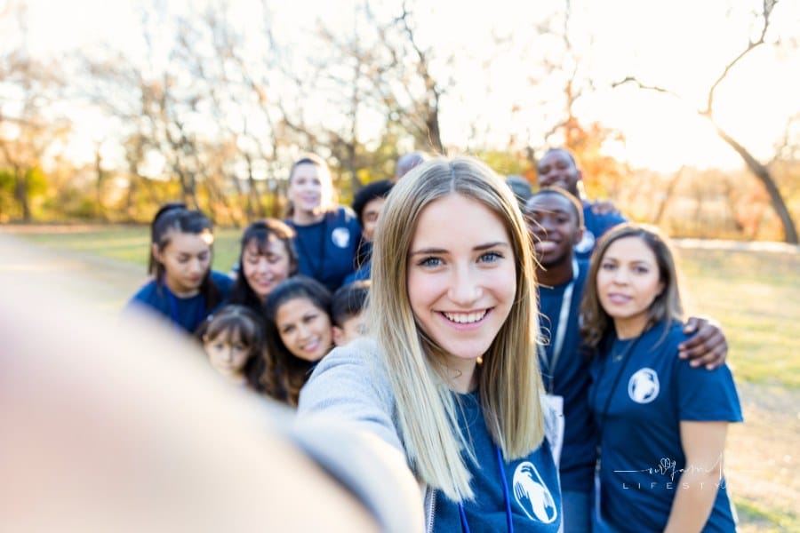 Young woman taking selfie during charity event