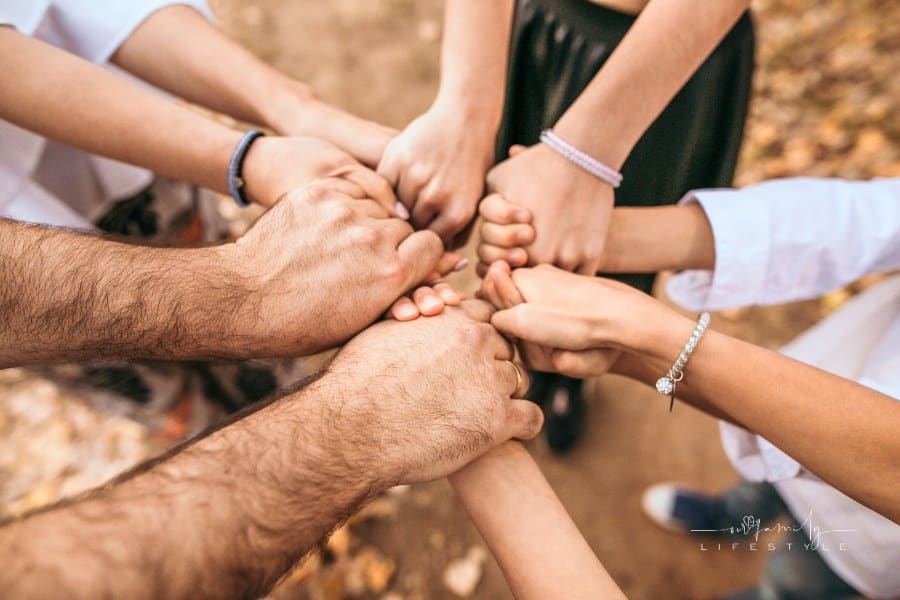 overhead view of family holding hands together in a tight circle