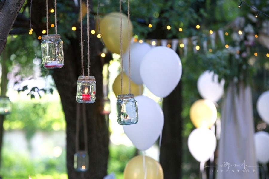 summer party set up with hanging jars and party balloons