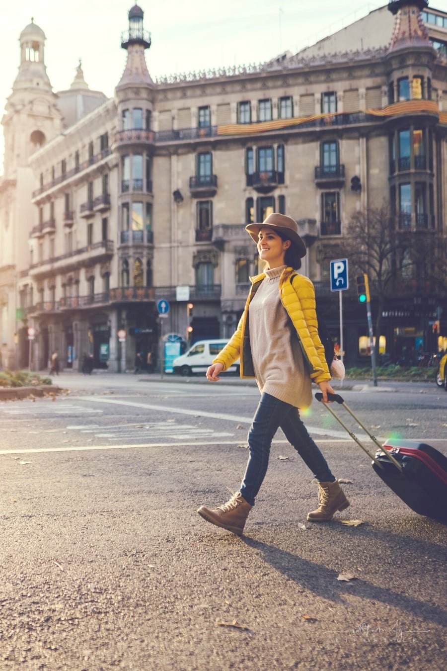 woman with suitcase walking in the street in Barcelona