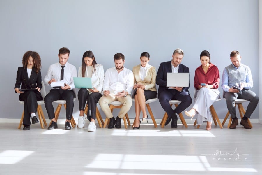 Diverse business team applicants, businesspeople sitting in row, queue waiting for job interview