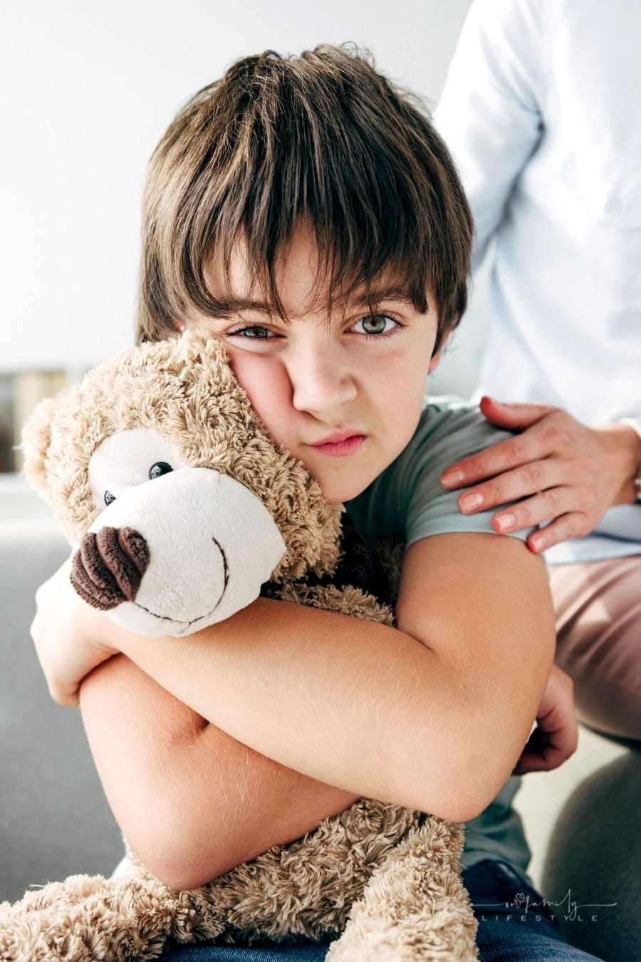 autistic child hugging a teddy bear