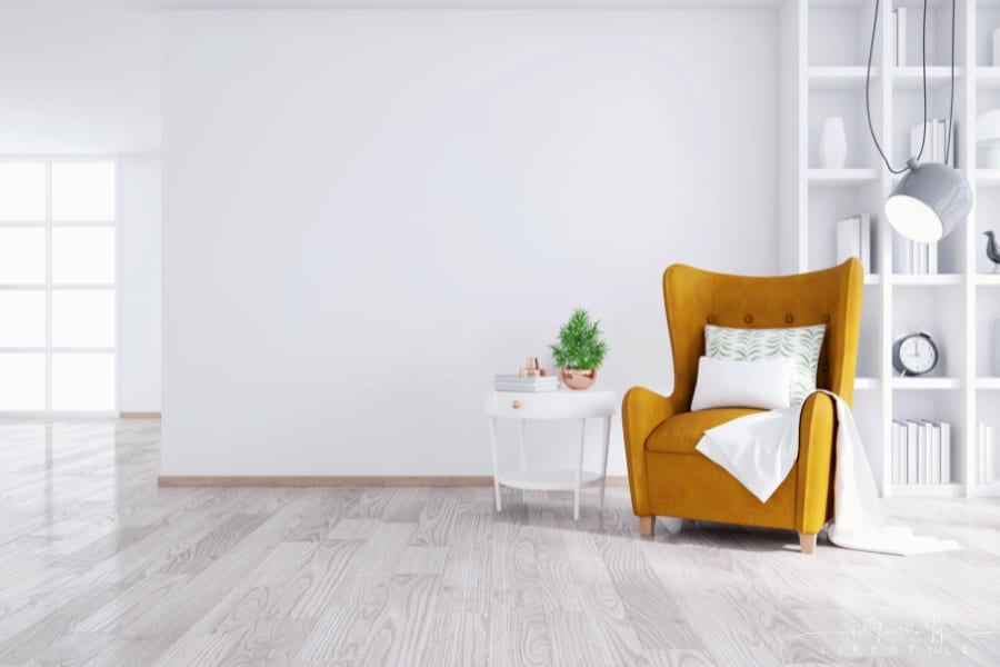 Modern and minimalist interior of living room ,Yellow armchair with white table on white wall and wood floor ,3d render