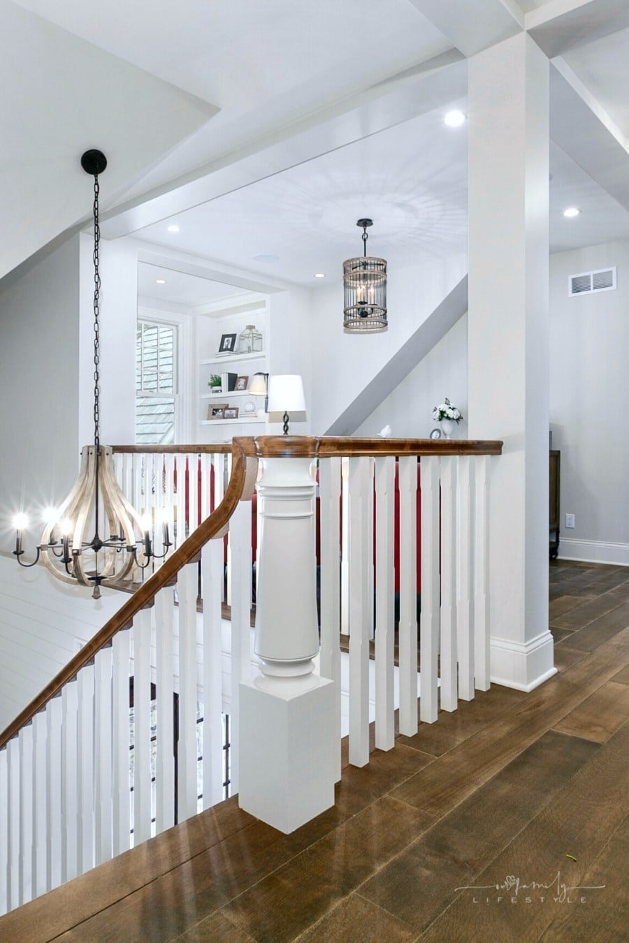 upstairs loft with light gray walls and wooden floors