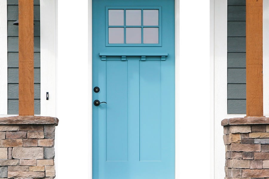 exterior front door of house painted a vibrant teal