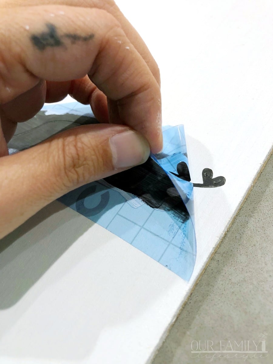 painting Cricut stencil vinyl on wooden sign