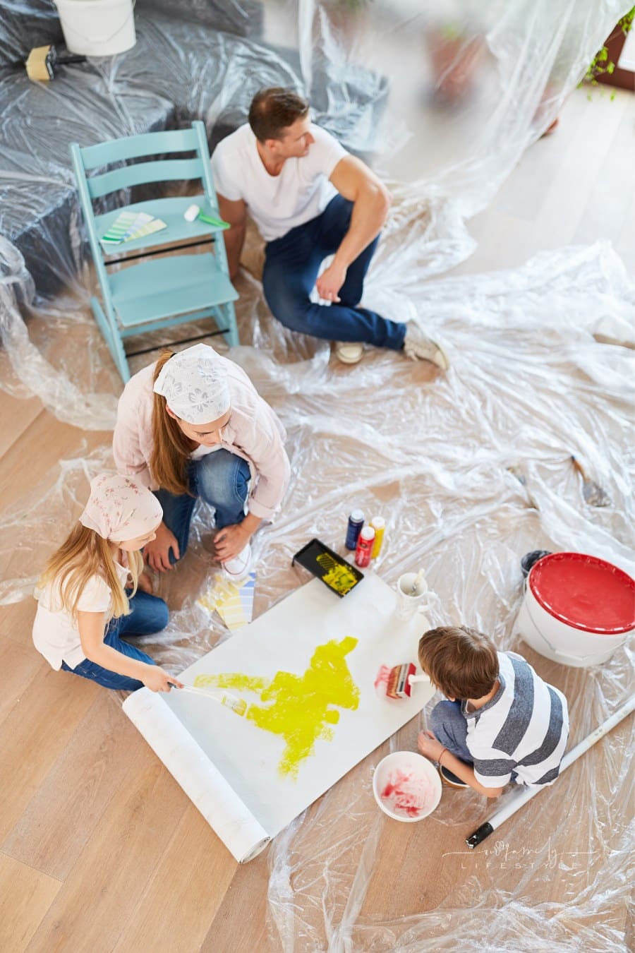 Two kids paint wallpaper at home renovation in new home