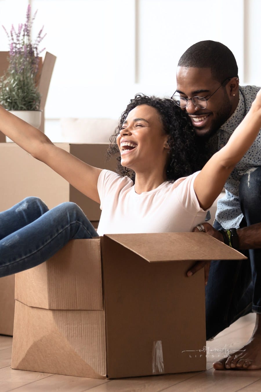 Happy black young couple have fun on moving day