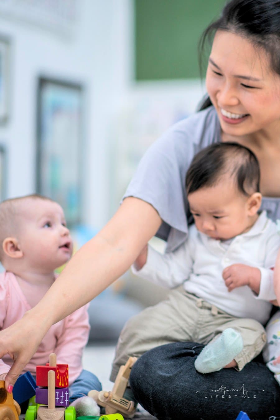 teacher playing with babies at day care