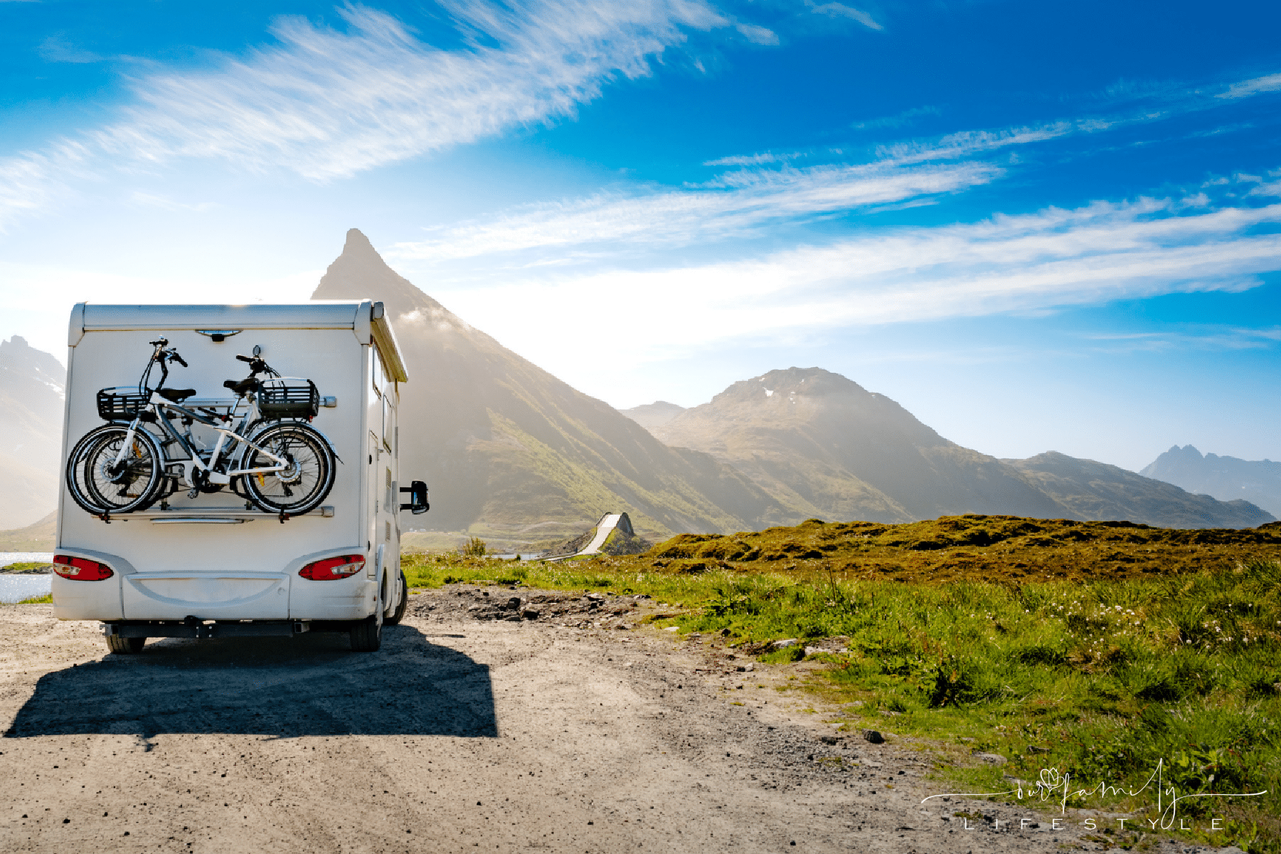 rv camper with bikes in the mountains