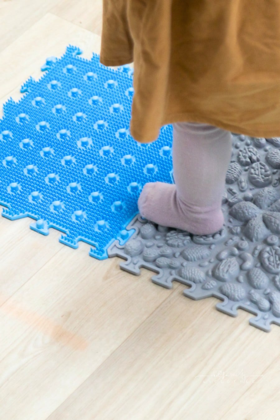 Toddler feet on orthopedic sensory mats