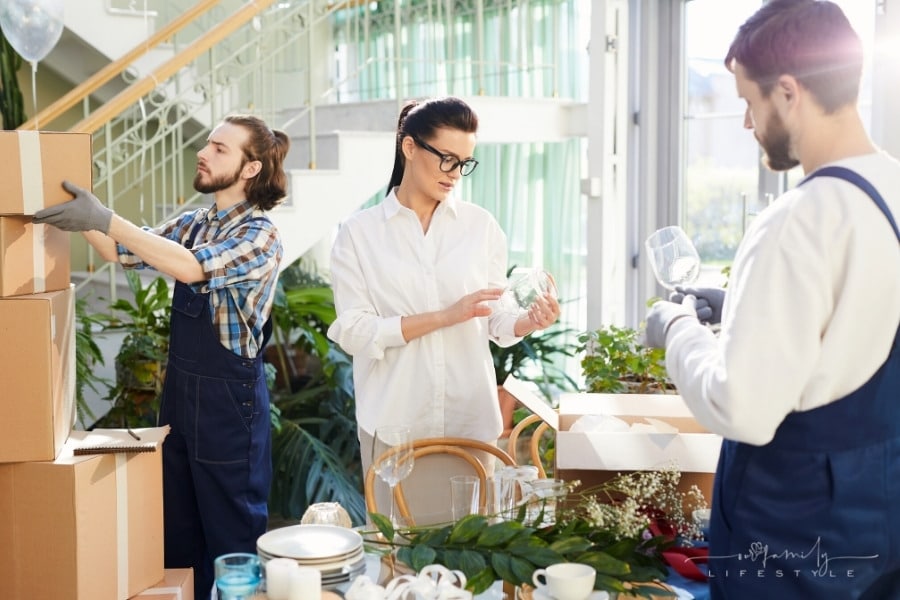 event planner checking wineglasses while setting up for wedding