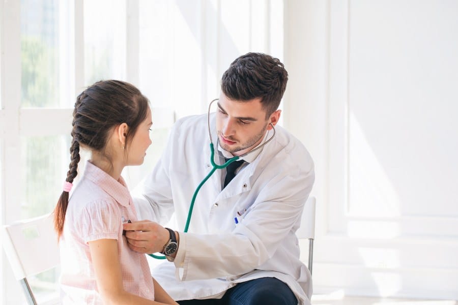 Pediatrician doctor examining child
