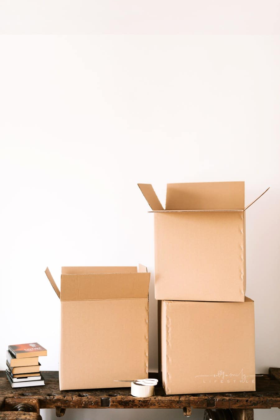 Cardboard boxes and books on wooden table
