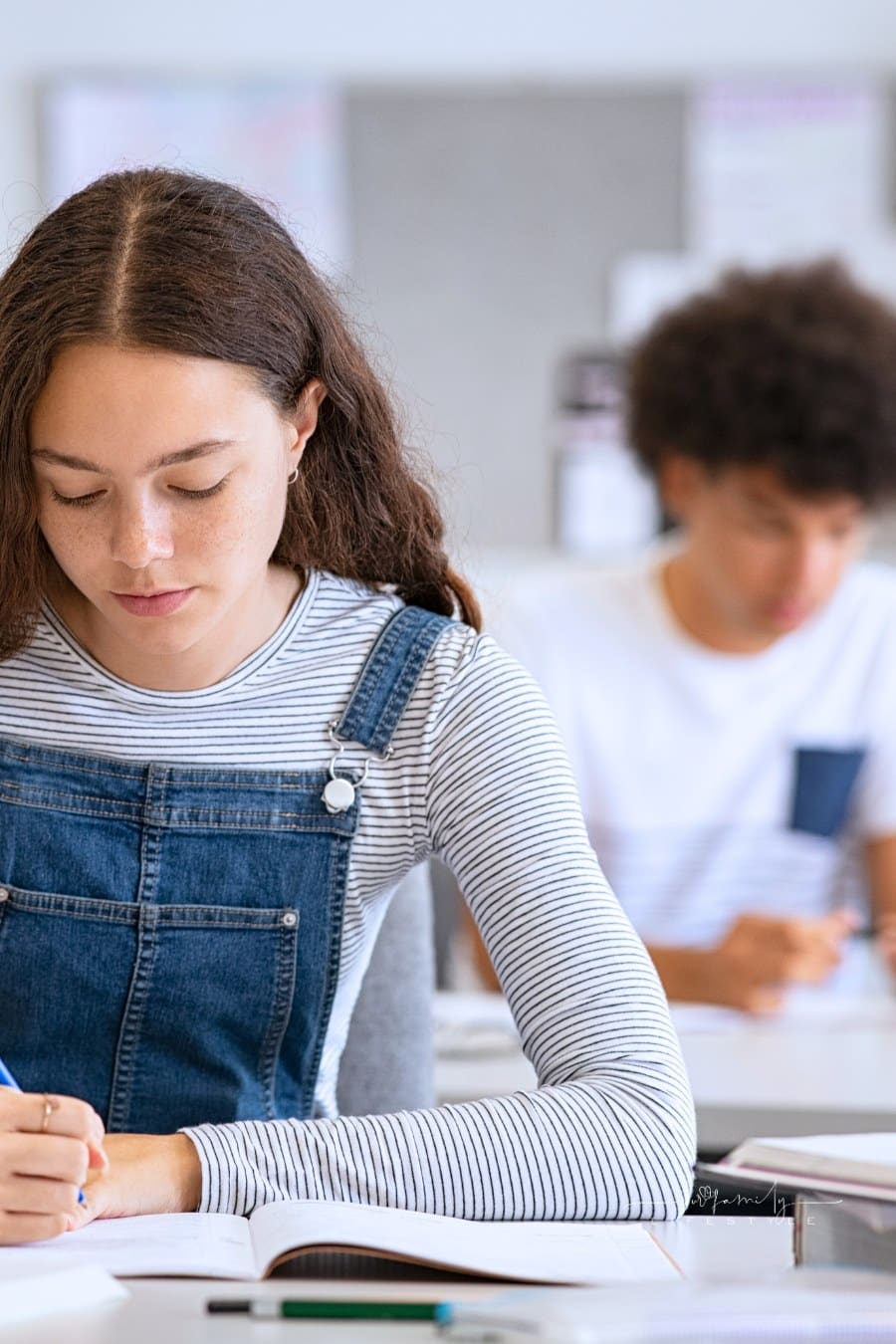 College Girl Studying with Concentration in Class