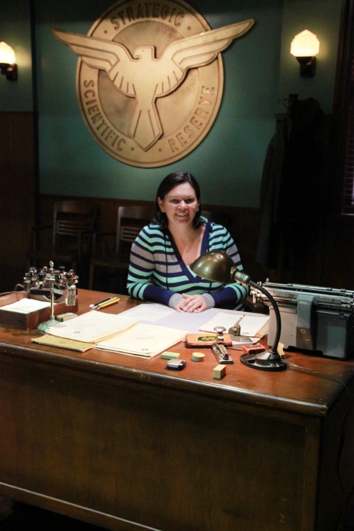 behind desk of Agent Carter