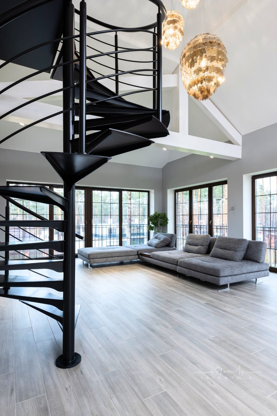 House interior with spiral staircase near couch and windows