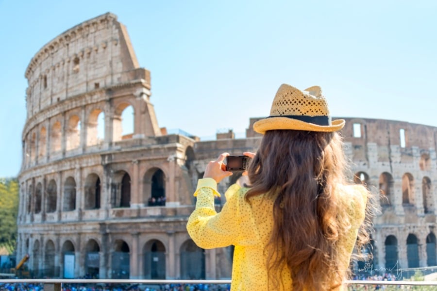 tourist taking picture of Colosseum in Rome, Italy