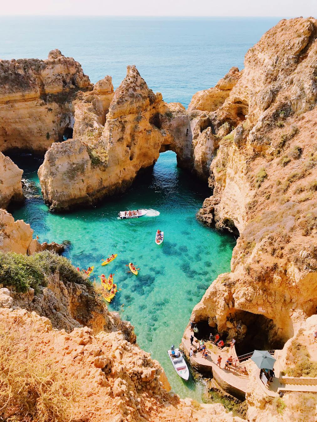 Stunning aerial view of cliffs and clear blue water at Lagos, Portugal, showcasing natural beauty.