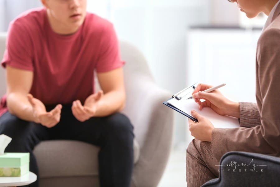 Psychotherapist Working with Young Man in Office, Closeup
