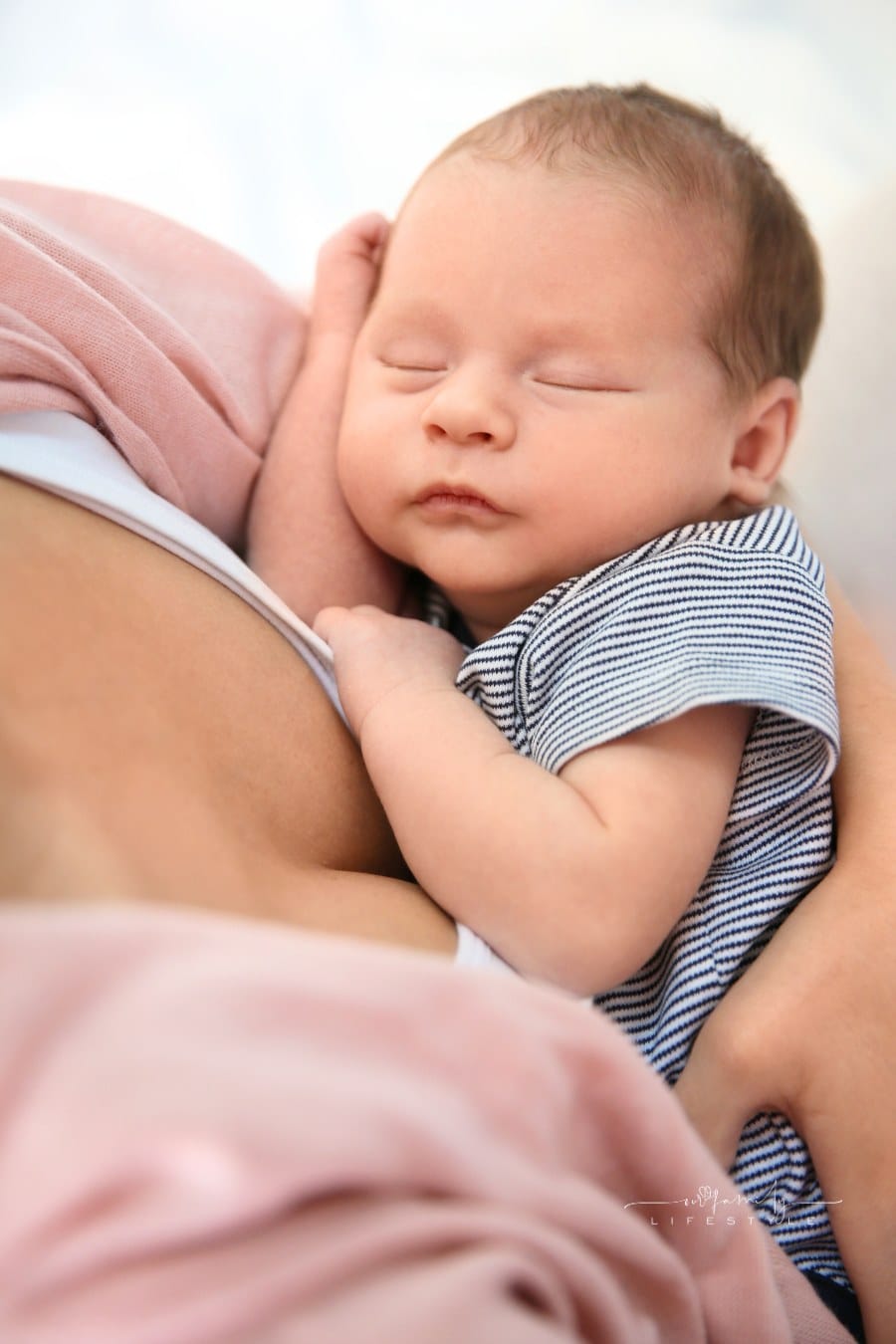 Young Woman Holding Her Newborn Baby, Closeup