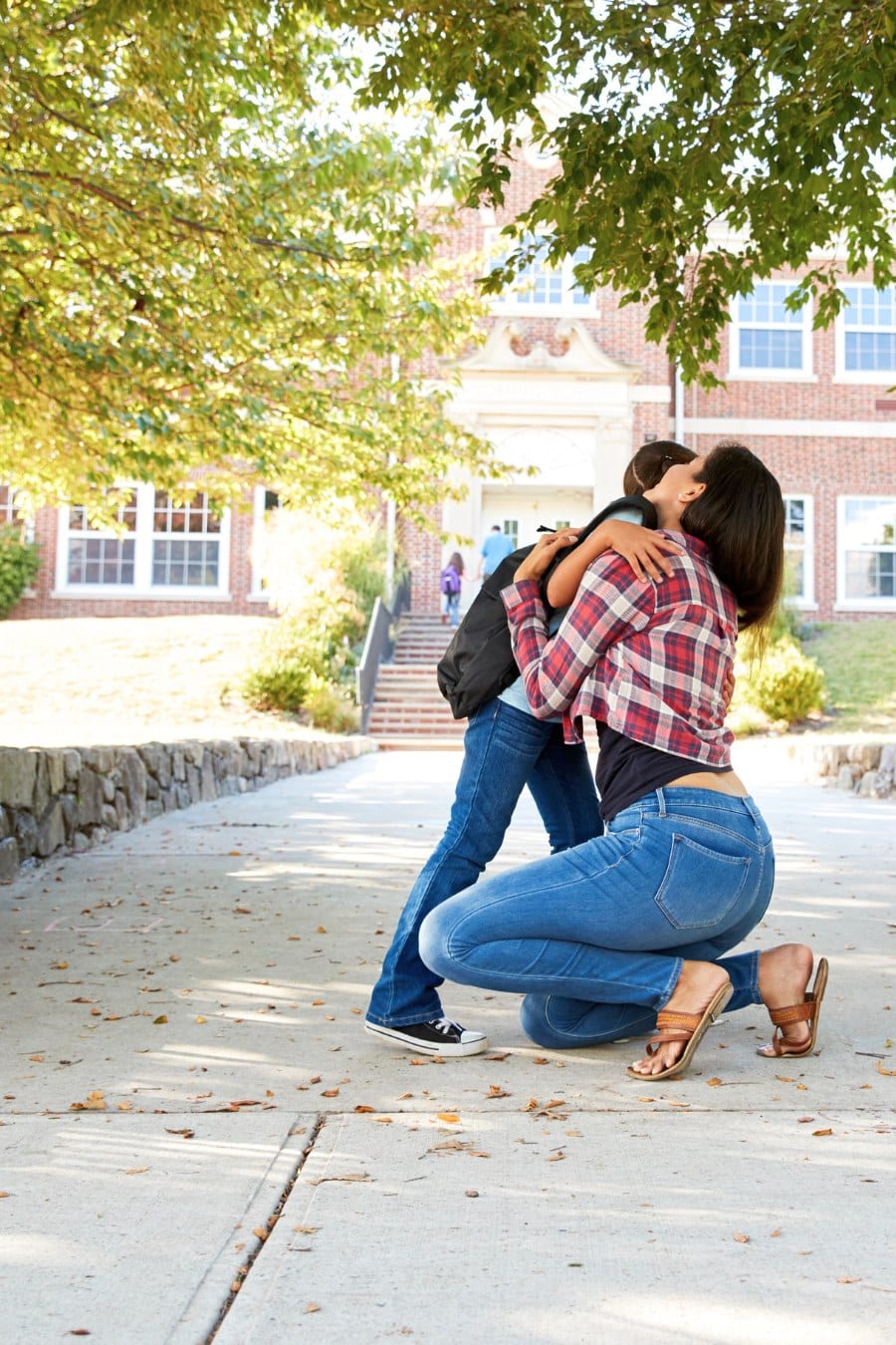 Mother Dropping off Daughter in Front of School Gates