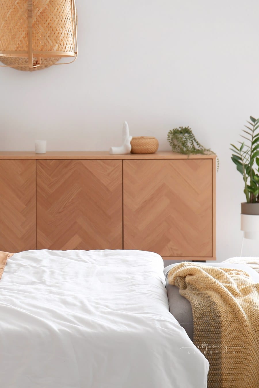 Interior of Stylish Bedroom with Bed and Wooden Cabinet