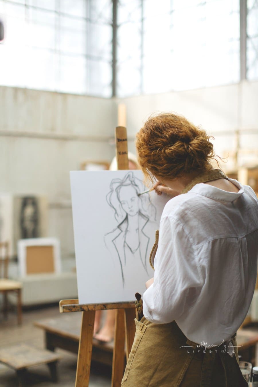 Woman In White Long Sleeves Sketching A Woman