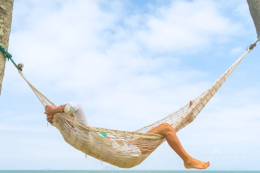 woman relaxing at the beach in a hammock