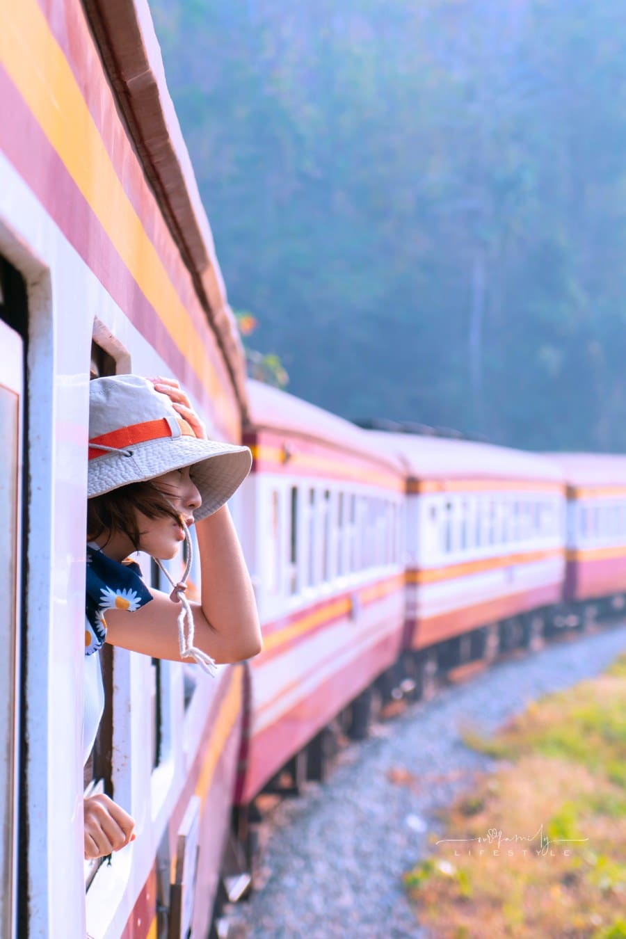 Woman looks out from window traveling by train