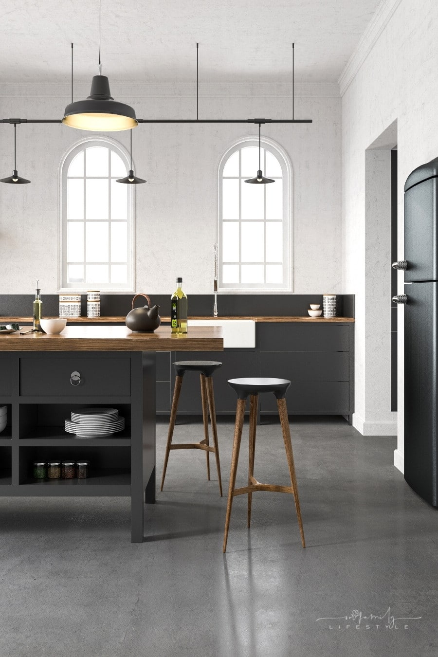 industrial kitchen with concrete floors and black cabinetry