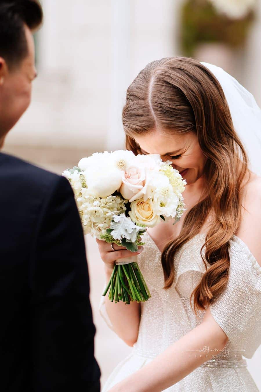 wedding ceremony. bride listens to groom's vow and cries.