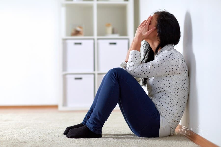 Unhappy Woman Crying on Floor at Home