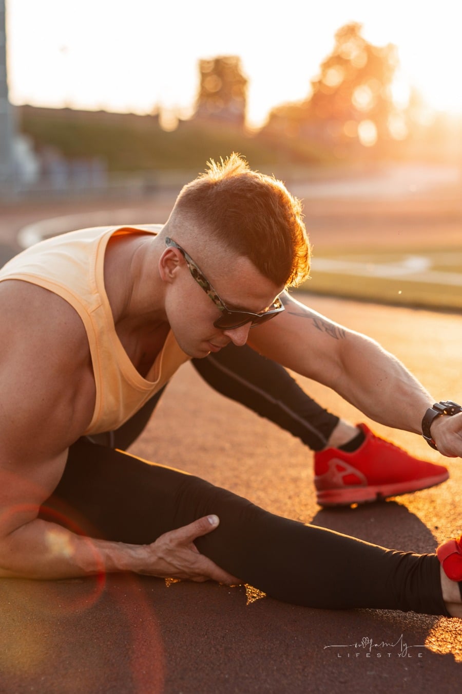 crossfit athlete in sunglasses stretching before workout