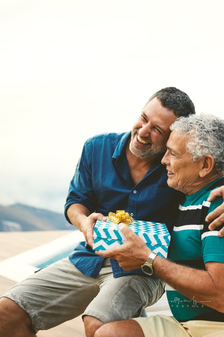 Son giving a gift for his father on father's day.
