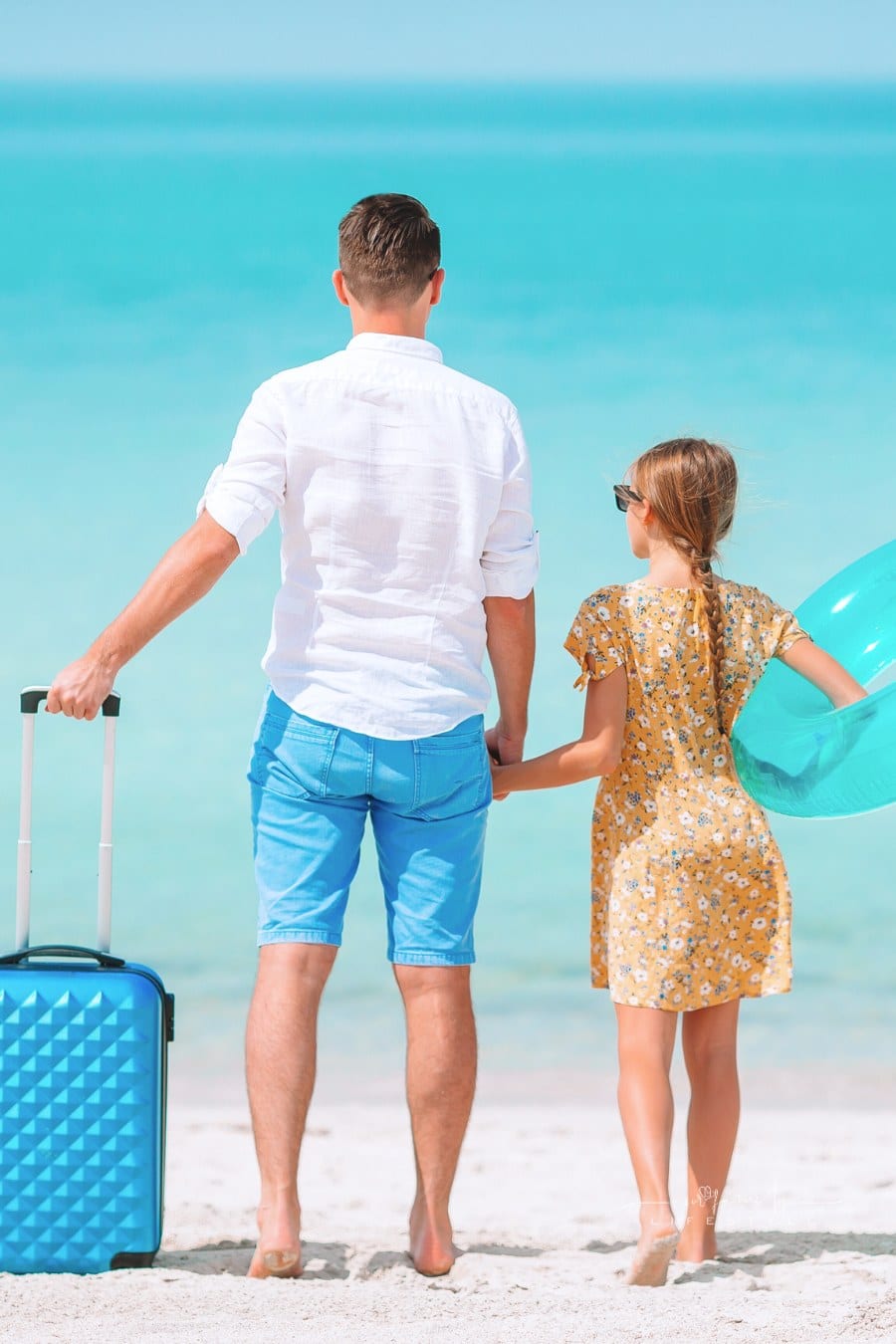 Little Girl and Happy Dad Having Fun during Beach Vacation