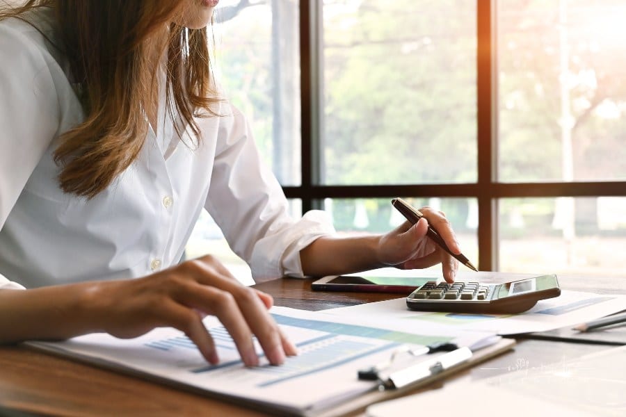 woman working with finance data using a calculator