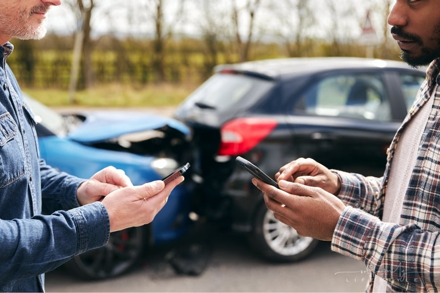 drivers exchanging insurance information after car accident